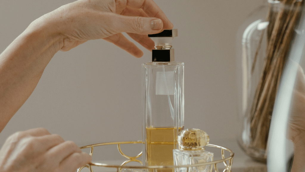 a woman holding perfume bottle